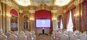 The Banqueting Room with theatre style seating and a large screen up front.