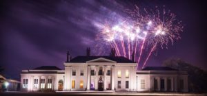 Fireworks over Hylands House at night.