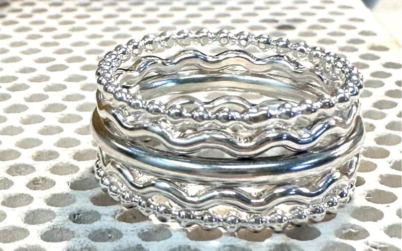 Five silver rings in a stack.
