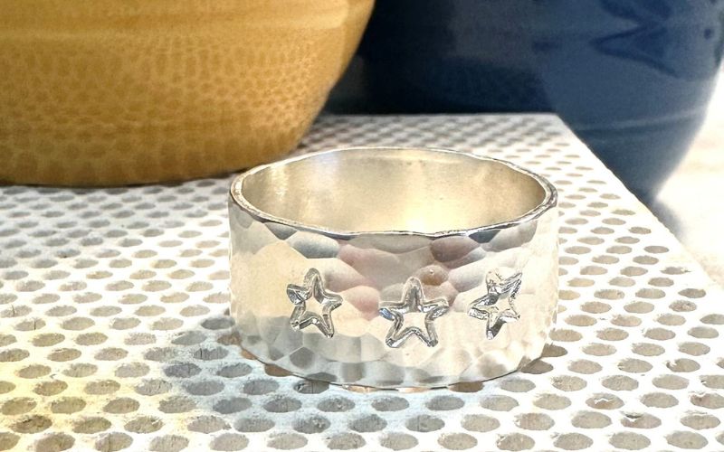 Silver ring stamped with stars.