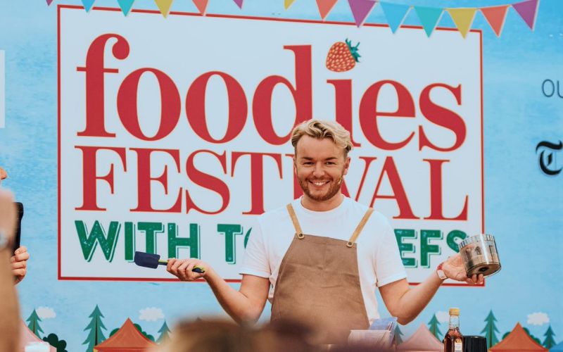 A chef demonstrating a recipe at Foodies Festival.