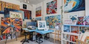 Inside Nicky Gayle's studio with colourful artwork filling the walls.