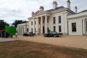 Filming taking place outside Hylands House with vintage cars and a green screen.