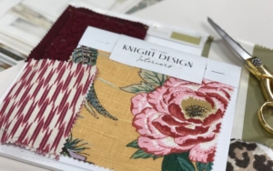 Fabric swatches with pink and red florals and patterns. 