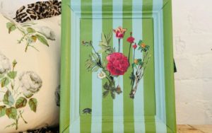Annie Sloan decoupage art featuring flowers and light and dark green stripes over a photo frame.