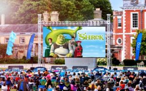 Shrek showing on a large outdoor screen.