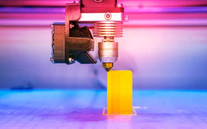A 3D printer printing out a design.