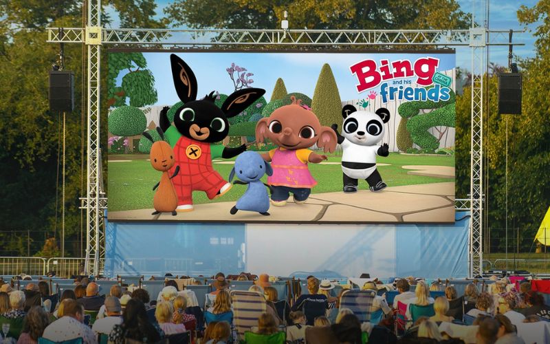 A film playing on a large outdoor screen