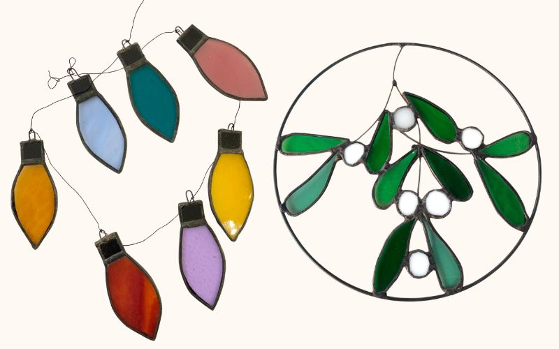 Stained glass decorations featuring mistletoe and Christmas lights.