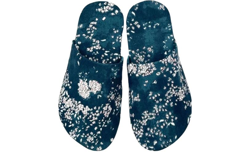Blue slippers with a white floral pattern.